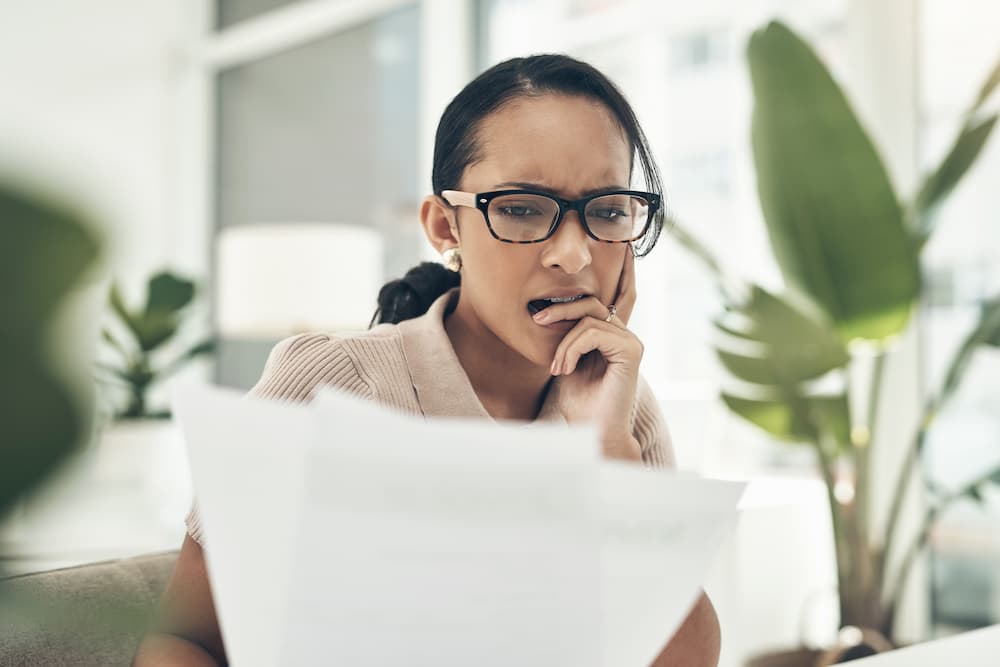 A woman holding a paper preparing or an interview.